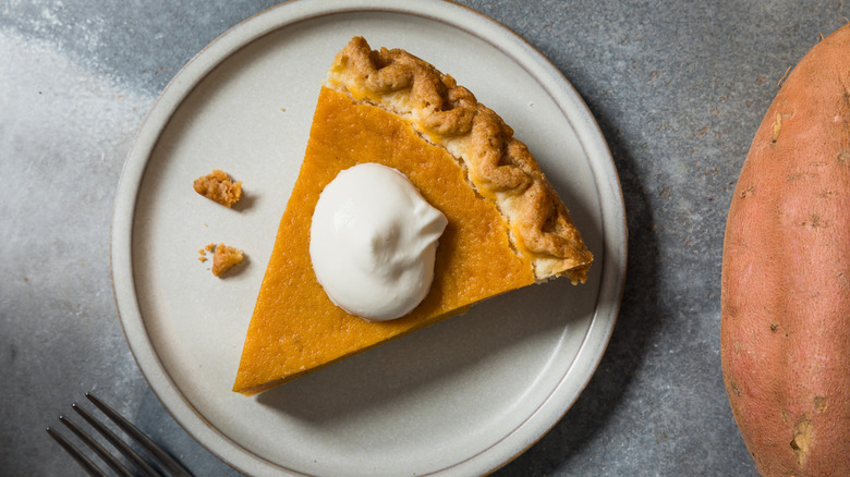 slice of sweet potato pie with dollop of cream