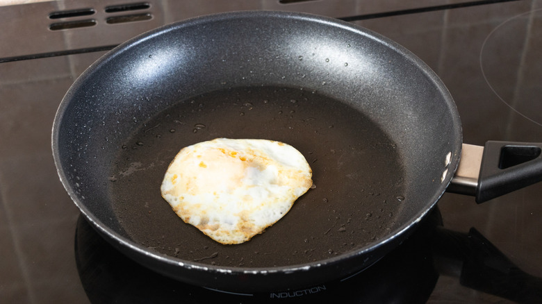Over-easy egg in frying pan on stovetop