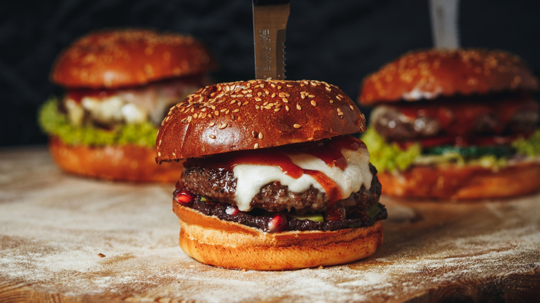 three burgers with cheese