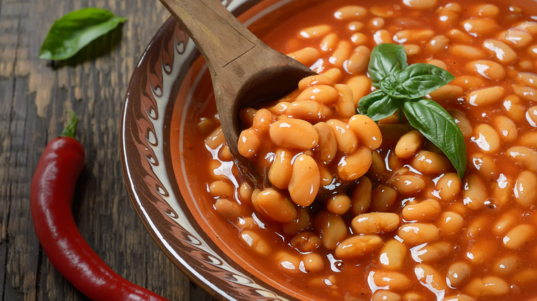 baked beans in bowl with wood spoon