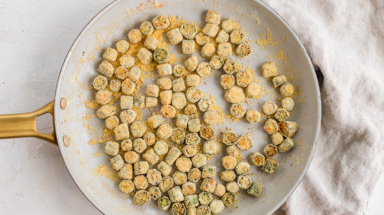 Pan-frying small pieces of breaded okra in a ceramic nonstick pan