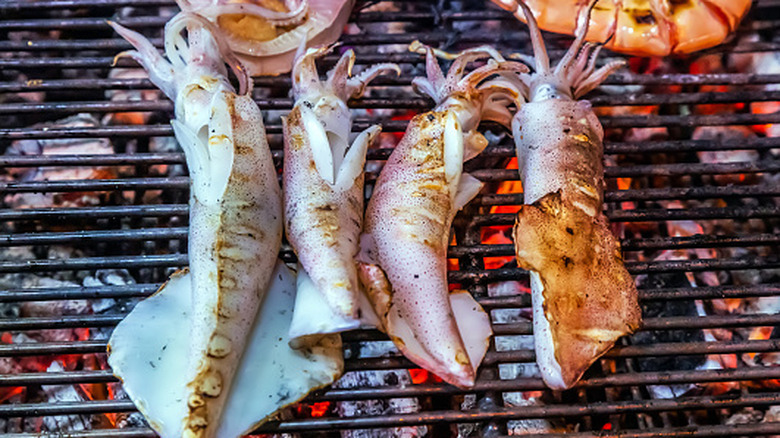 Pieces of calamari on a barbecue grill