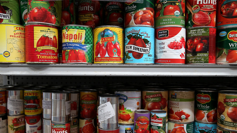 Cans of tomatoes on a shelf
