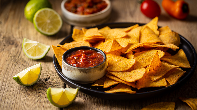 chips and salsa with sliced lime