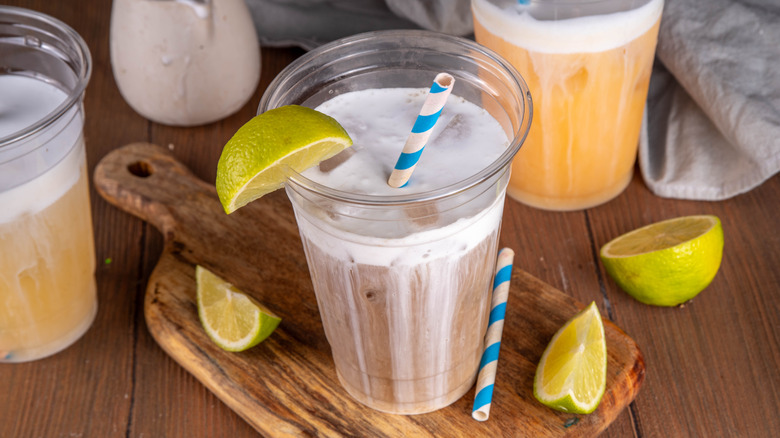 Three dirty sodas with lime wedges