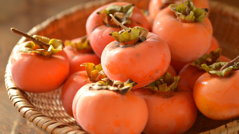 A basket of sun dappled fuyu persimmons