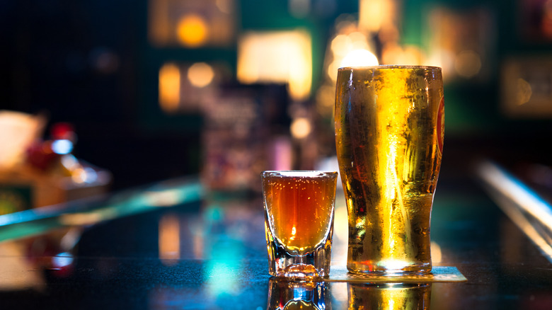 Pint of beer and shot on bar