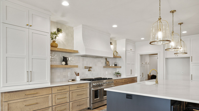 Pendant lights over an island in a white kitchen
