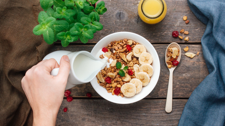 Foodie assembling a bowl of loaded cereal