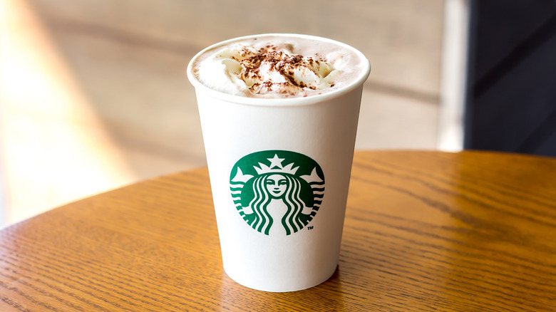 cinnamon latte at starbucks in white cup on table