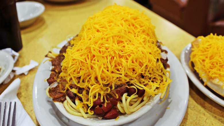 A plate of Cincinnati chili piled with cheese