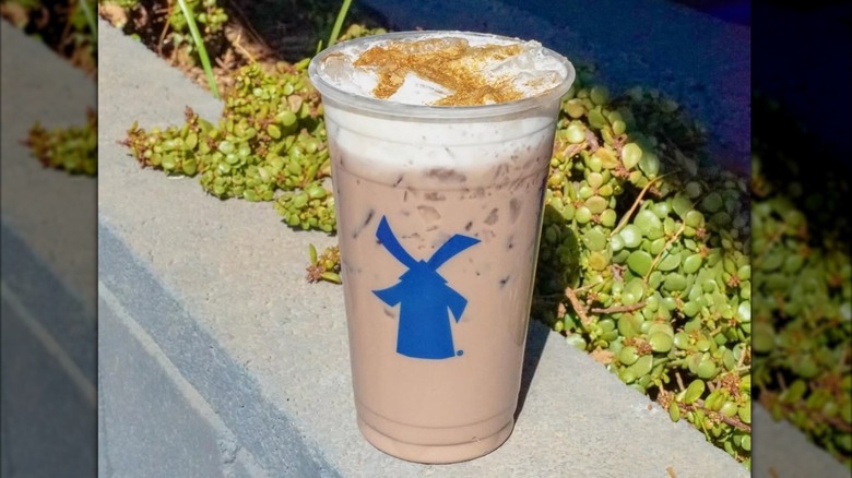 Iced chocolate drink with whipped topping in Dutch Bros branded plastic cup