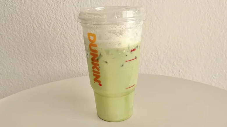 Dunkin' pumpkin matcha latte on table