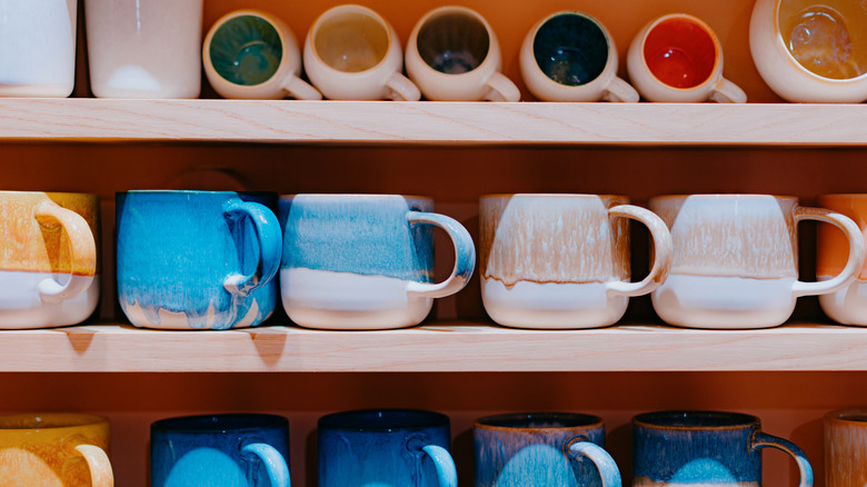 Rows of mugs on shelves