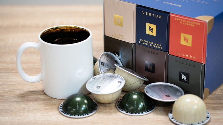 Nespresso boxes and pods with a mug