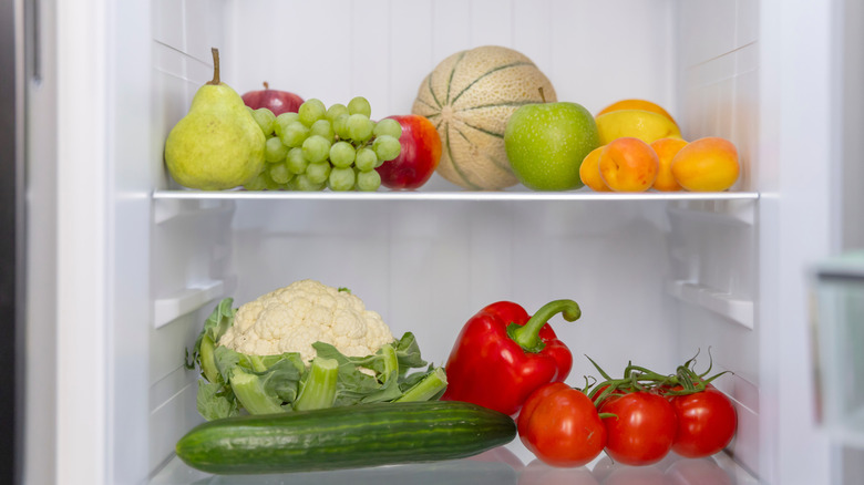 Various produce on refrigerator shelves