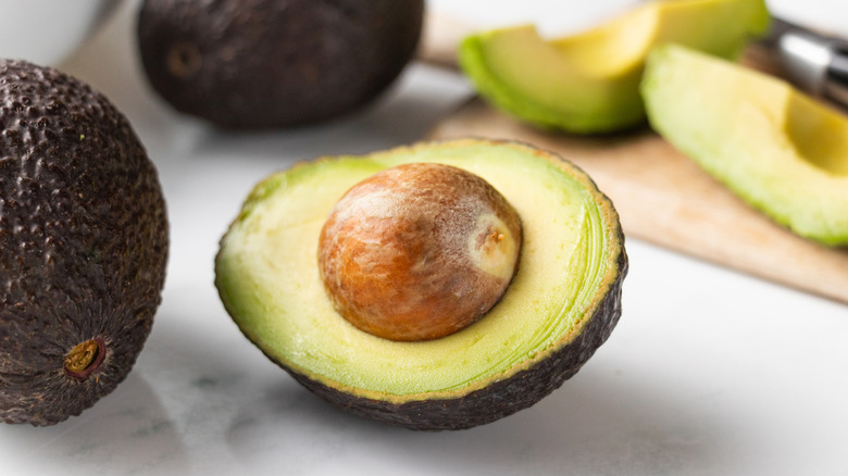 Close up of halved avocado with stone in
