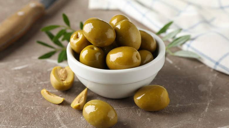 bowl of green olives stone counter