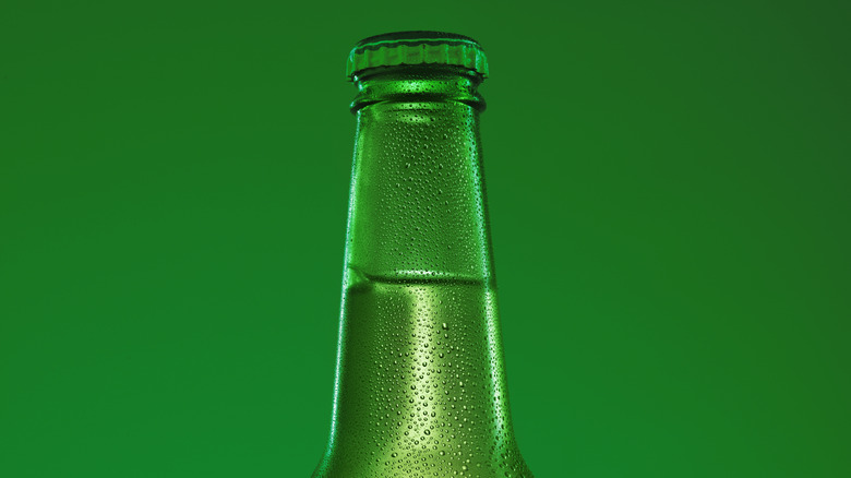 Bottle with condensation on green background