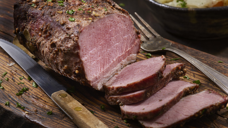 Smoked corned beef on wooden board