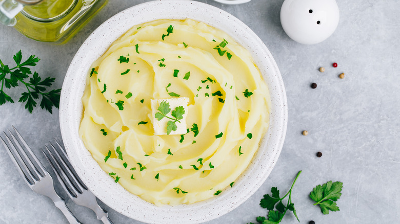 mashed potatoes with butter in white bowl