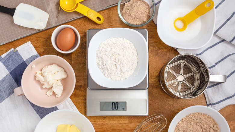 Ingredients for cake with flour on digital scale
