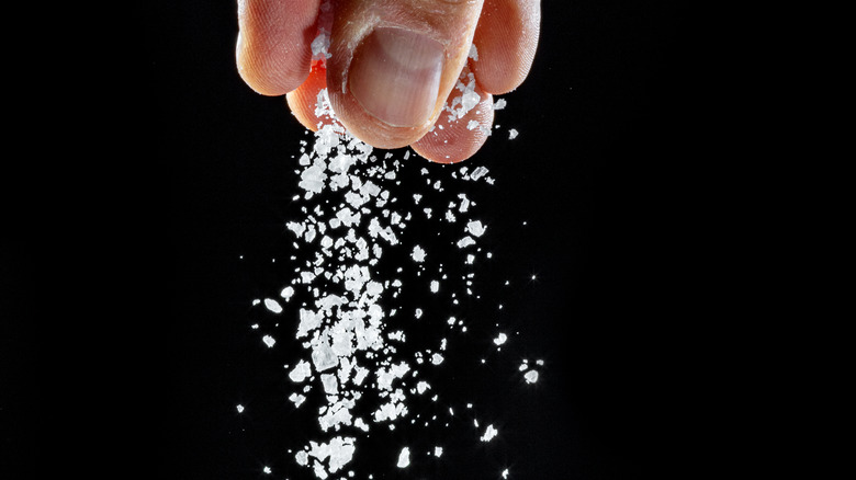 hand sprinkling kosher salt