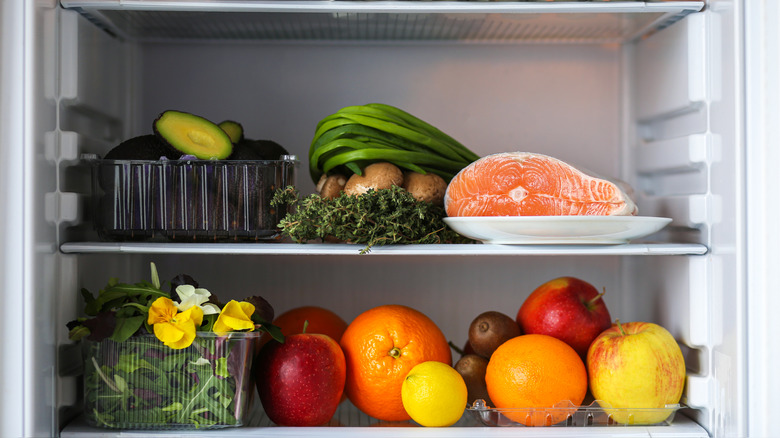 open fridge with fresh produce and salmon
