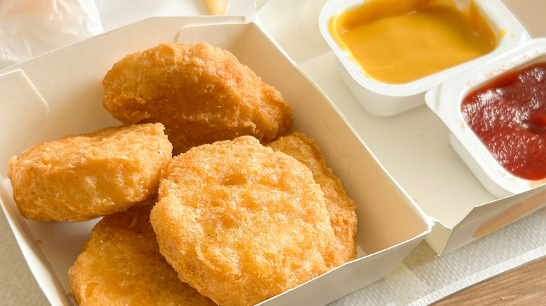 McDonald's nugget being dipped in sauce