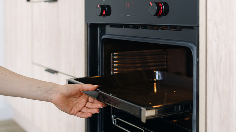 removing broiler pan from oven
