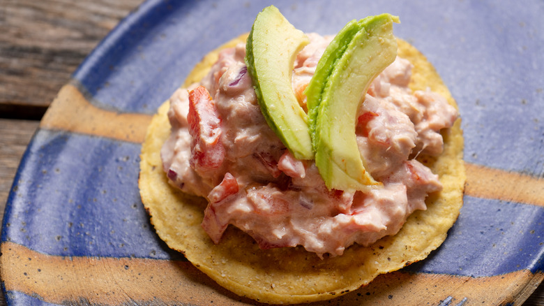 Tostada shell topped with tuna salad