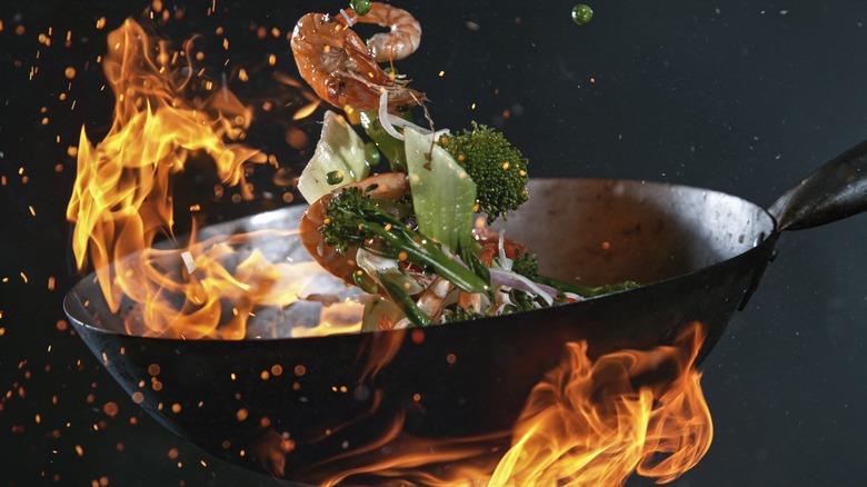 a wok surrounded by flames