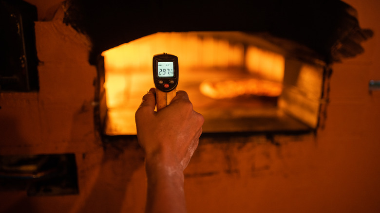 infrared thermometer pointed at pizza oven