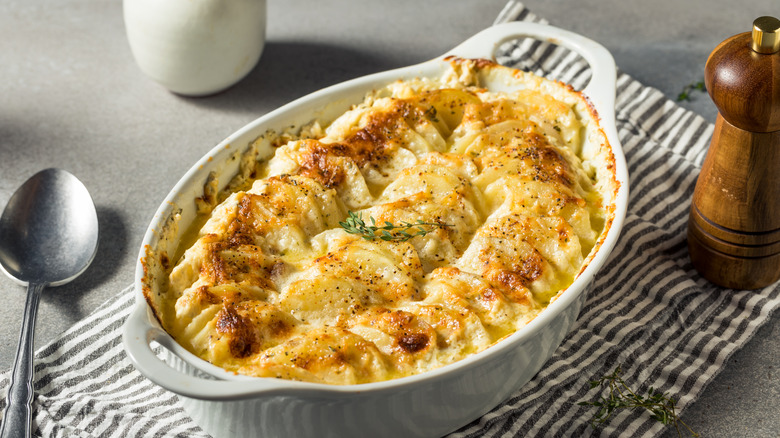 homemade scalloped potatoes in white baking dish