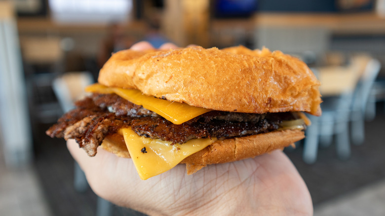 A person holding a Culver's burger.