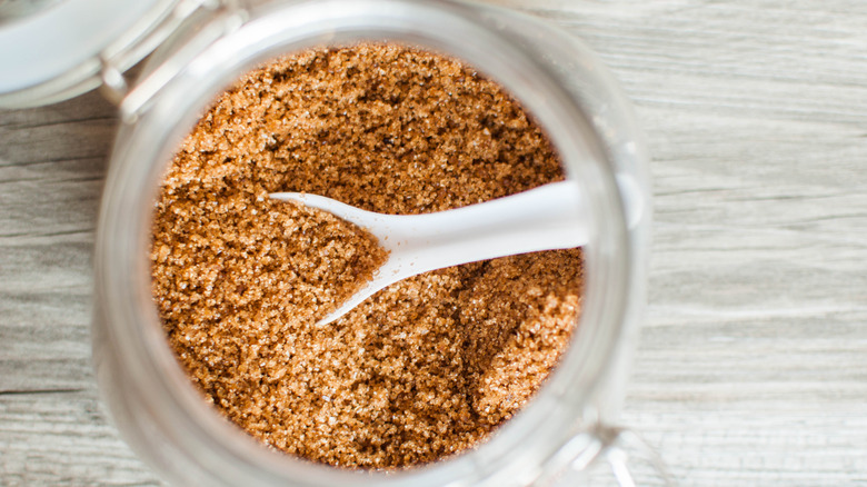 Brown sugar in glass jar with spoon