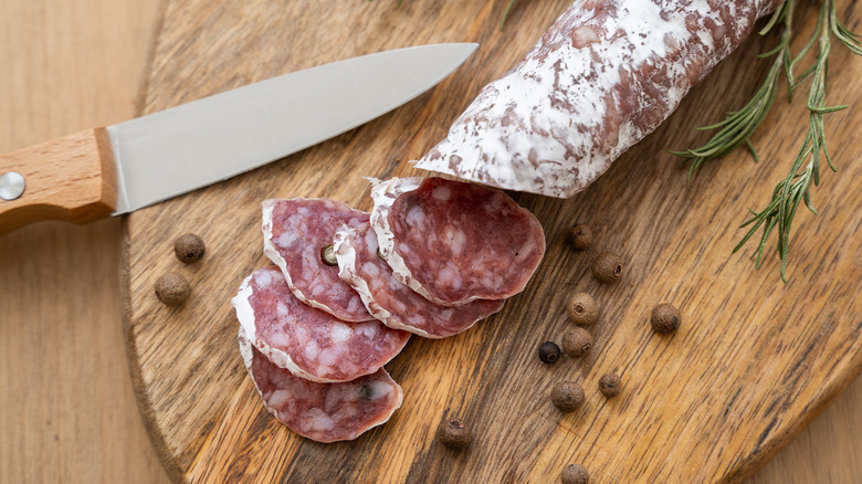 Salami with white mold on a cutting board