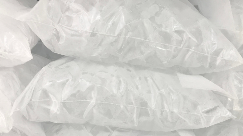 Stacked bags of ice in freezer