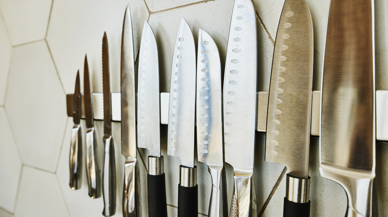 Close-up of knives on magnetic strip