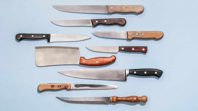 Variety of knives on blue background