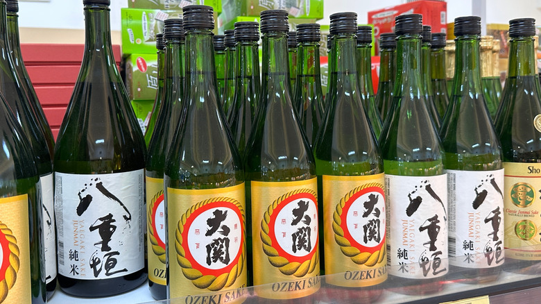 Different bottles of sake arranged on a shelf