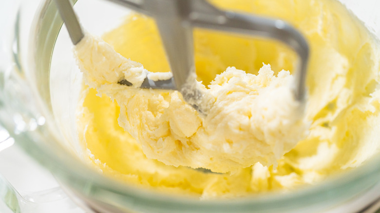 A stand mixer creaming butter and sugar