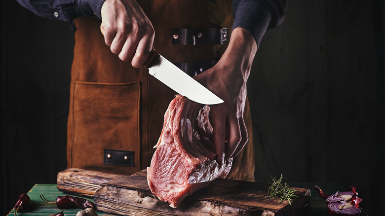 Knife cutting into meat