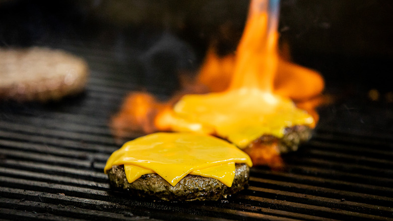 torching burger patties with cheese