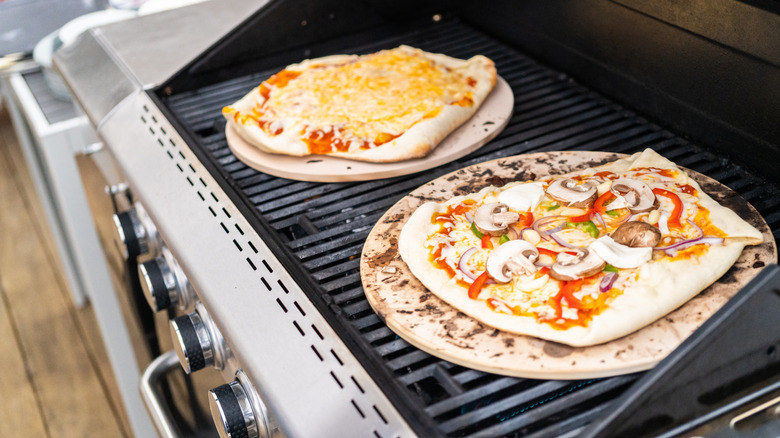 pizza on pizza stones on a gas grill