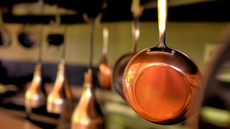 Copper pans hanging from ceiling