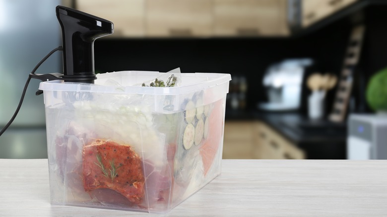 A sous vide cooker with floating packets