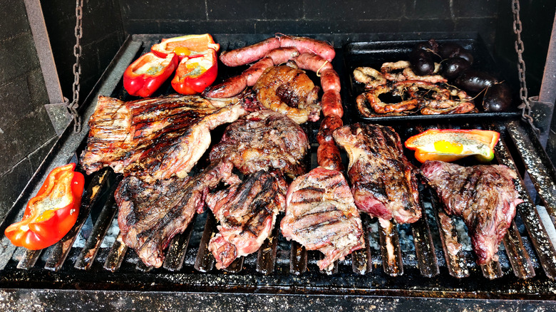 meats cooking on asado grill