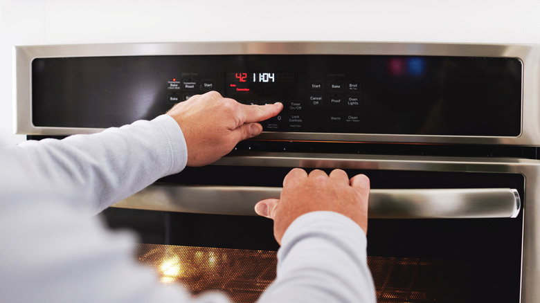 A person using the air fryer setting on oven
