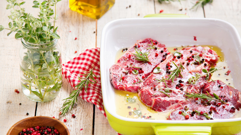 Steaks marinating in dish